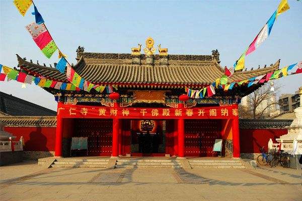 Guangren Temple is a small but full-blown Tibetan-style temple, with maroon walls, white stupas, prayer wheels, multicolored pennants flapping in the wind, and lamas in typical maroon robes with yellow undergarments.